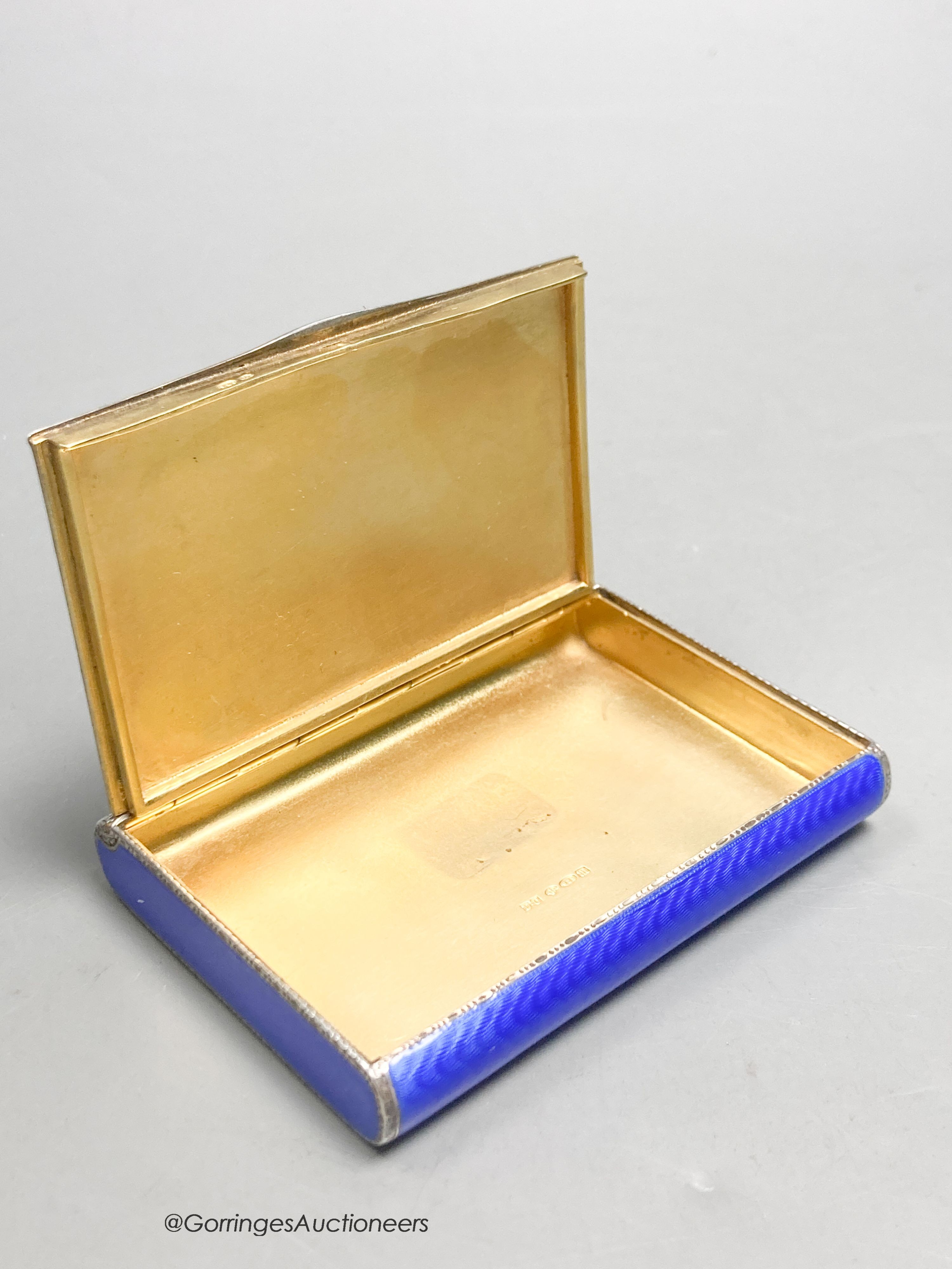 A 1920's continental silver and blue guilloche enamel rectangular box with hinged cover, import marks for DC, London, 1927, 77mm by 55mm by 12mm